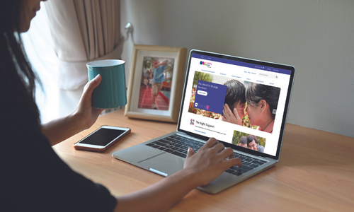 Woman browsing the Enabling Guide on her laptop.