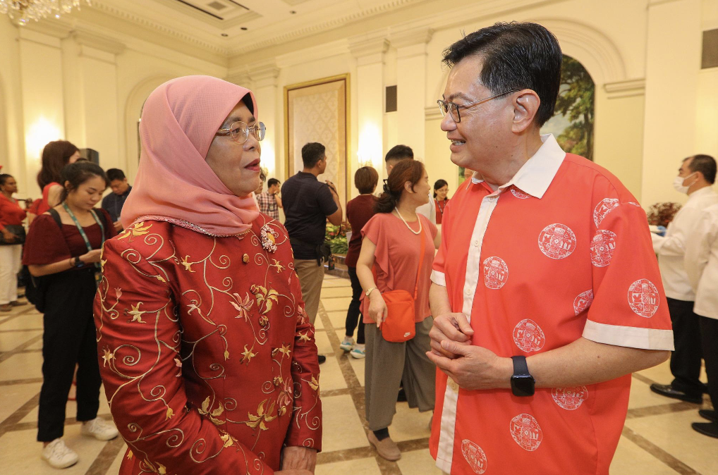 DPM Heng Swee Keat speaking with President Halimah Yacob, dressed in the shirt designed by Singapore Fashion Runway.