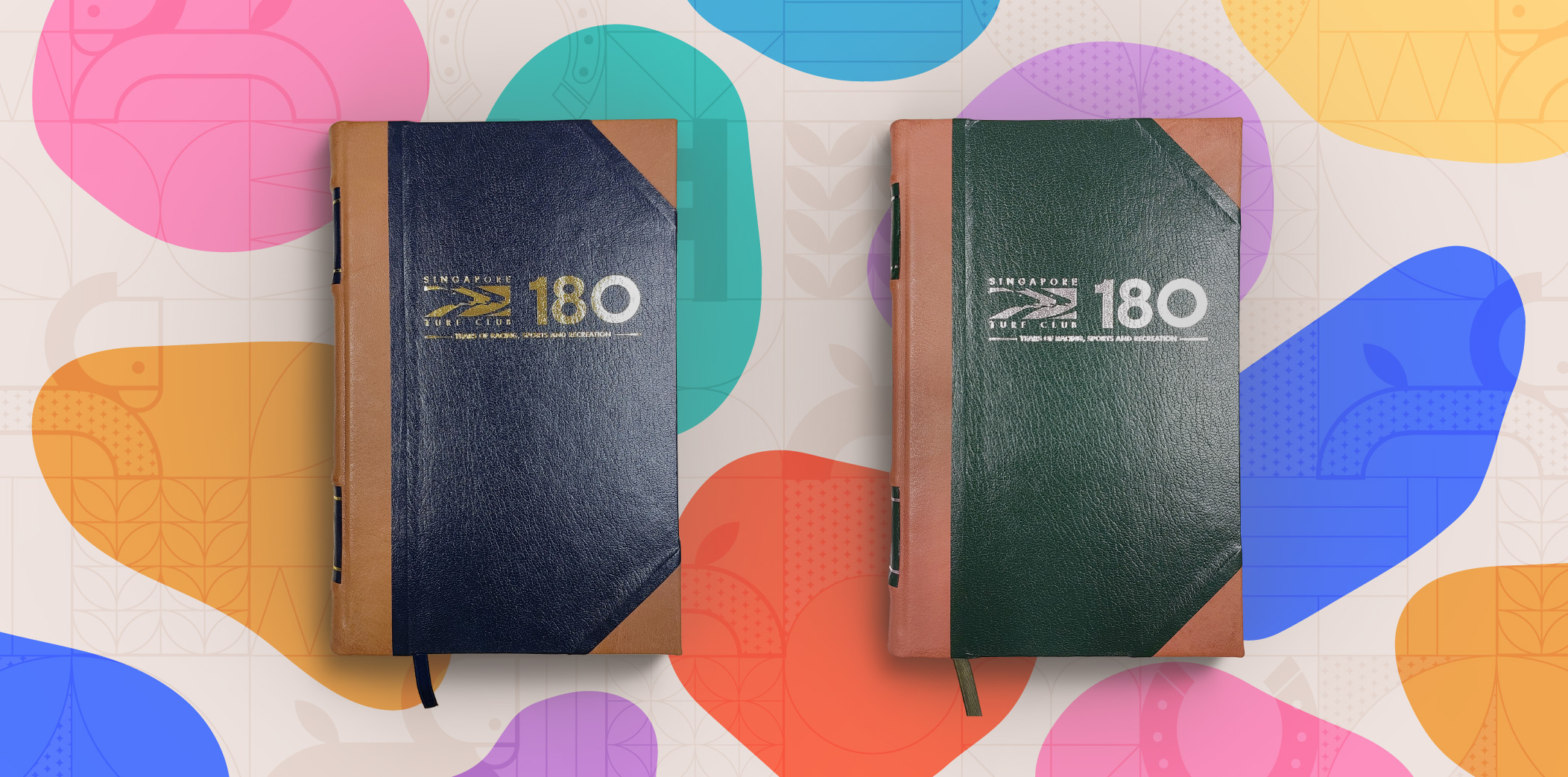 2 customised half-leather bound journals in blue on the left and green on the right.