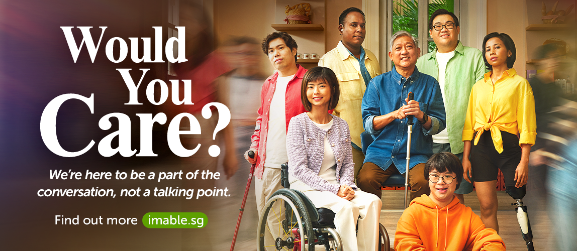 A group of persons with disabilities in colourful clothing standing in the middle of a moving crowd. Text on banner reads, Would you care? Find out more at imable.sg.