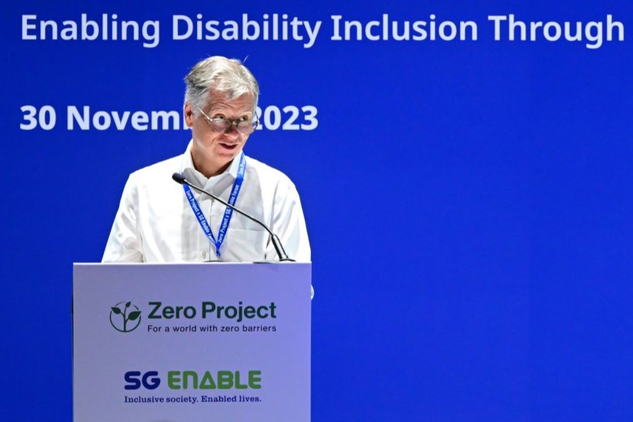 Photo of a man standing at a podium giving a speech.